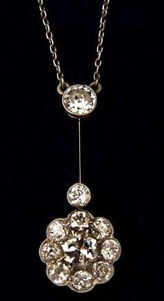 Appraisal: A DIAMOND SET PENDANT in the form of a cluster