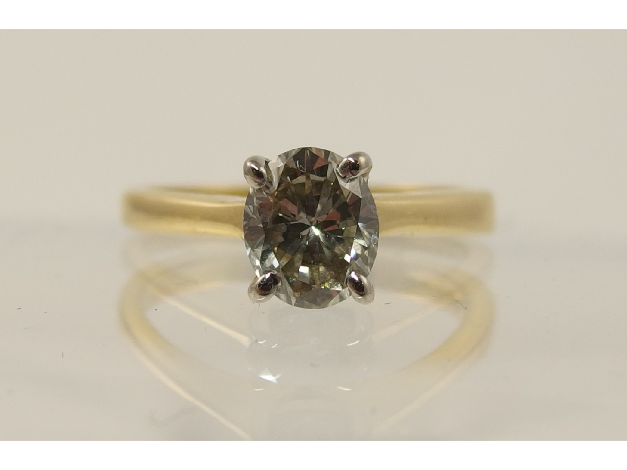 Appraisal: An ct yellow and white gold oval cut diamond solitaire