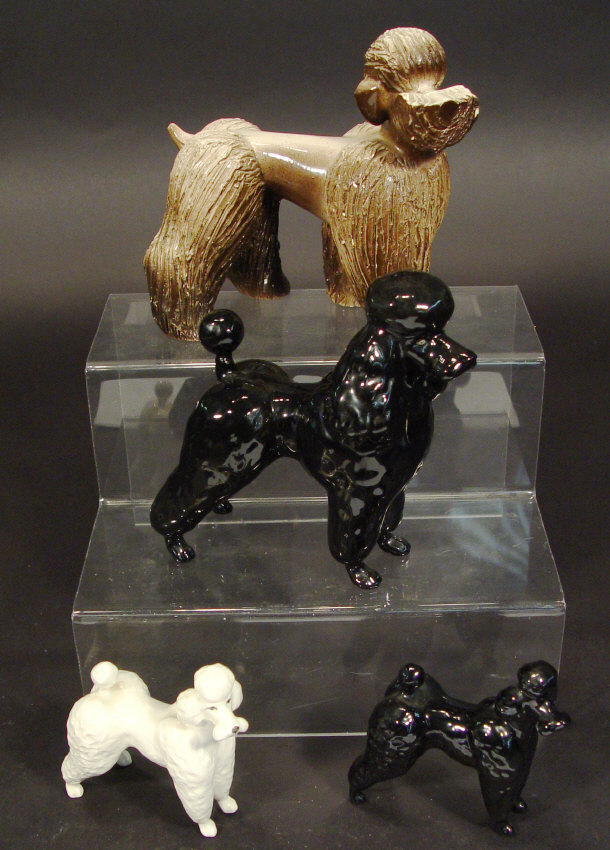 Appraisal: Four Beswick poodles two decorated in a black gloss glaze