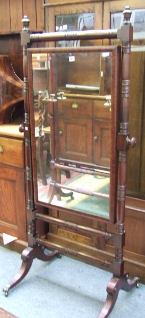 Appraisal: A late Regency mahogany cheval mirror with turned supports and