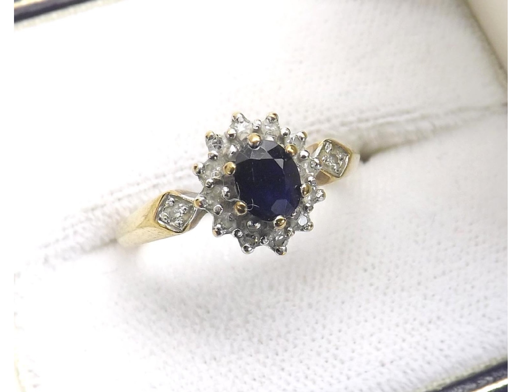 Appraisal: Sapphire and diamond ct yellow gold cluster ring with set