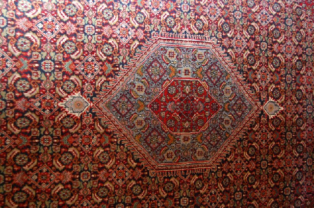 Appraisal: A PERSIAN RUG With a repeating diaper pattern x cm