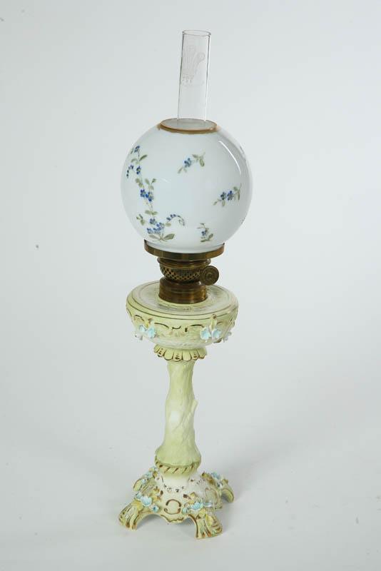 Appraisal: KEROSENE LAMP Porcelain base and font has embossed gilt accents