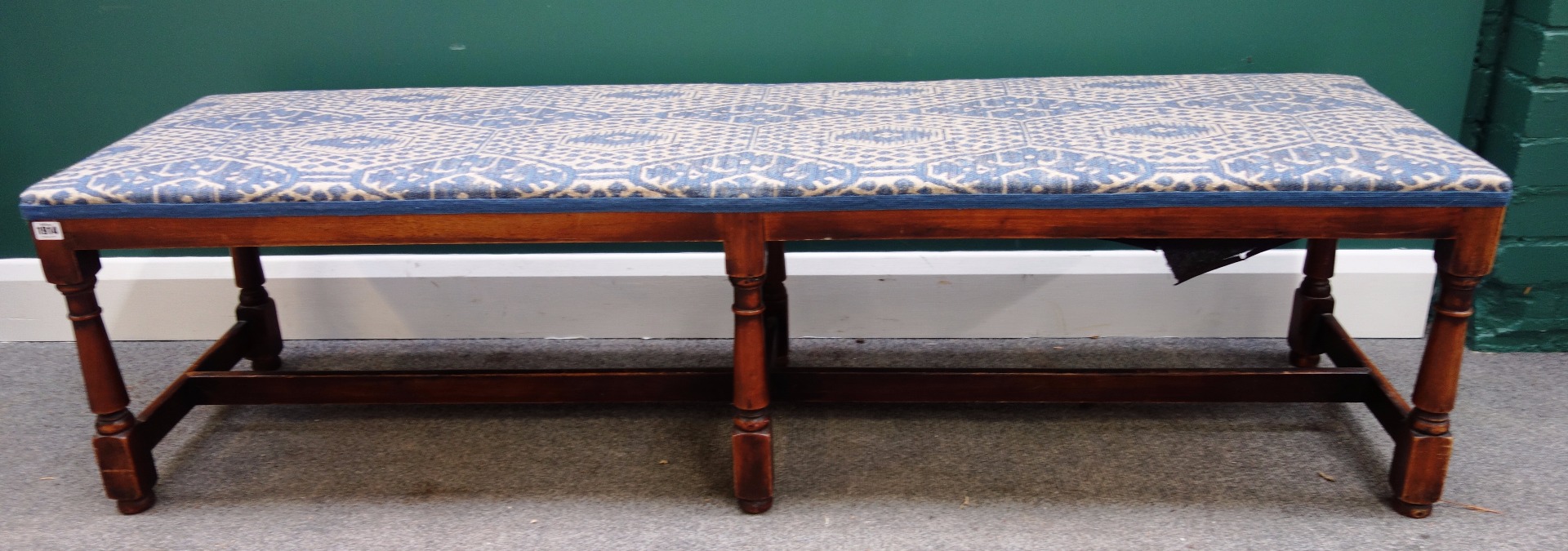 Appraisal: A large th century style mahogany footstool on turned supports