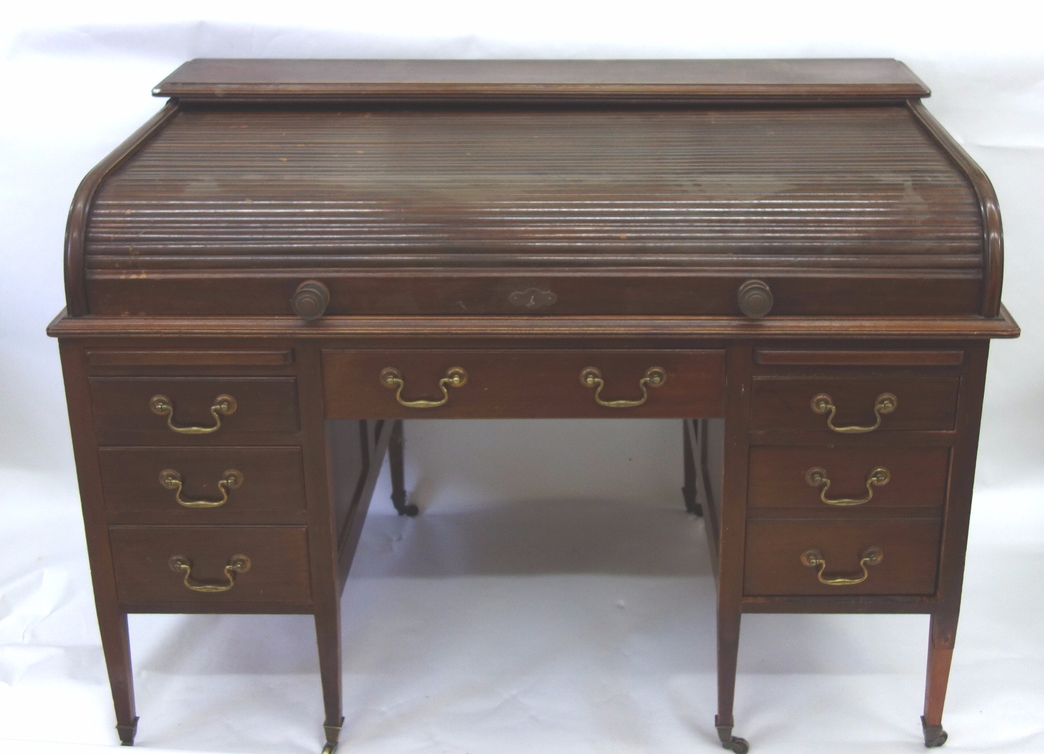 Appraisal: An early th century mahogany kneehole desk enclosed by a