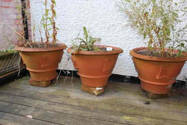 Appraisal: A SET OF FOUR TERRACOTTA PLANTERS possibly by the Whichford