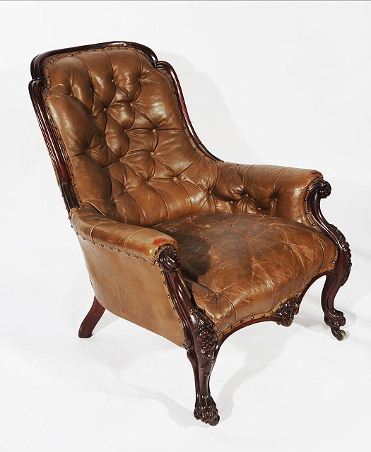 Appraisal: AN OLD MAHOGANY FRAMED LEATHER UPHOLSTERED LIBRARY CHAIR with shaped