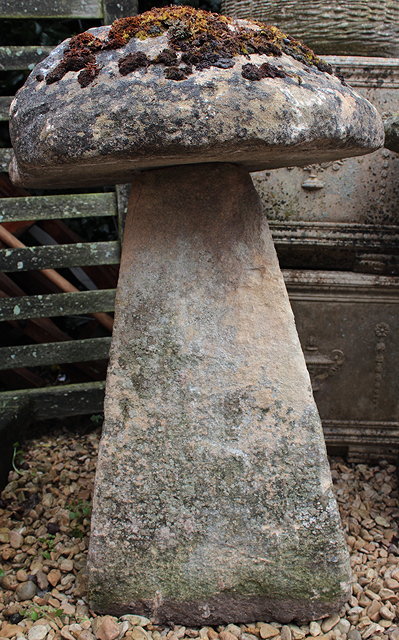 Appraisal: AN OLD STADDLE STONE with circular top and spreading rectangular