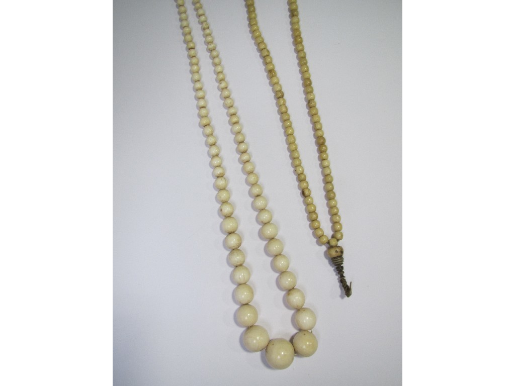 Appraisal: Two strings of beads one ivory and one bone