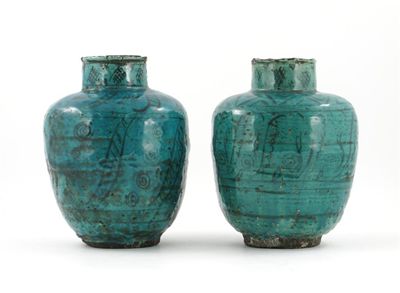 Appraisal: A pair of middle eastern open pottery vases decorated with