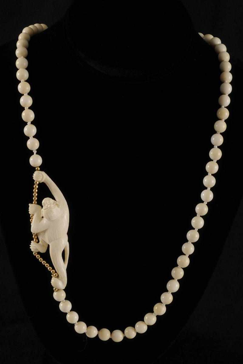 Appraisal: TWO IVORY BEADED NECKLACES Together with one faux ivory beaded