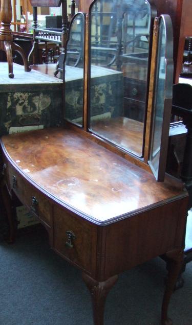 Appraisal: A mid th century walnut bow front dressing table the