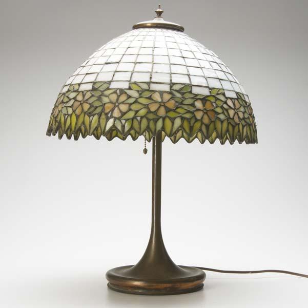 Appraisal: LIGHTING American glass and bronze table lamp the leaded geometric