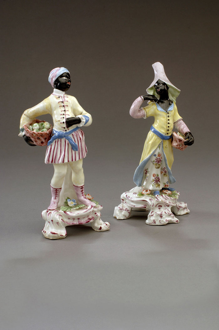 Appraisal: TWO BOW PORCELAIN FIGURES OF A BLACKAMOOR PAGE AND MAID