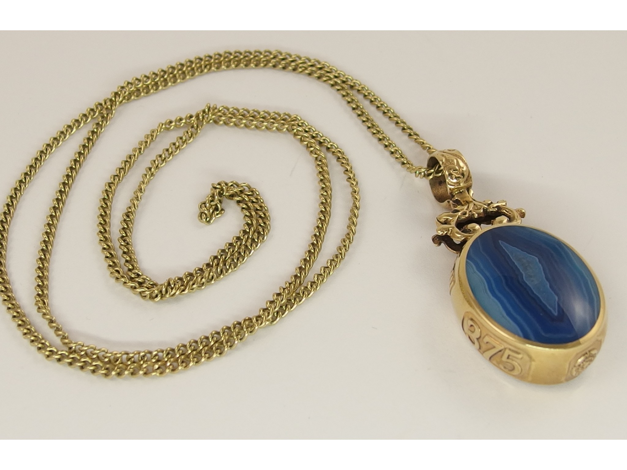 Appraisal: A ct dyed blue agate double sided fob pendant with