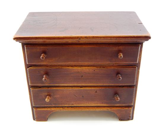 Appraisal: Miniature chest th C American reddish brown stain projecting applied