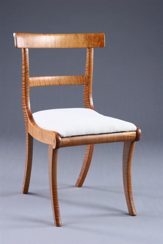 Appraisal: AMERICAN CLASSICAL TIGER MAPLE KLISMOS CHAIR th century Back-scrolled crest