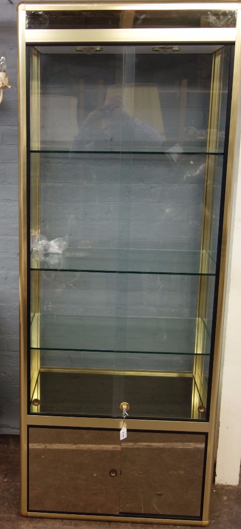 Appraisal: A contemporary gilt metal frame glazed display cabinet the sliding