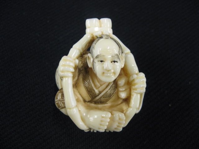 Appraisal: Carved Ivory Netsuke of a Man seated in bamboo cage