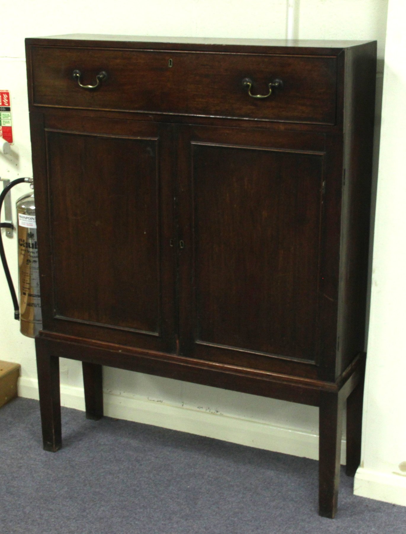 Appraisal: A George III and later mahogany cabinet fitted a single