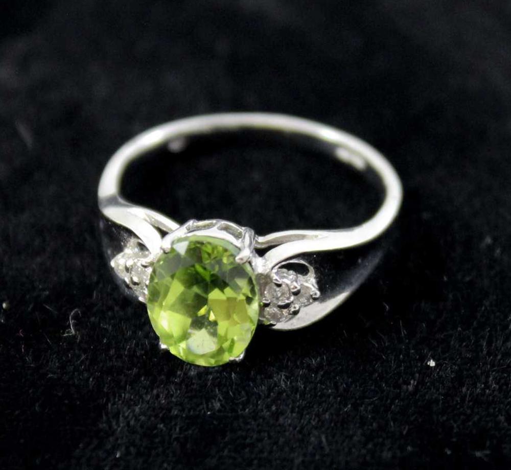 Appraisal: PERIDOT DIAMOND AND FOURTEEN KARAT WHITE GOLD RING with three