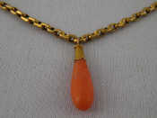 Appraisal: A yellow metal tests carat gold coral pendant and chain