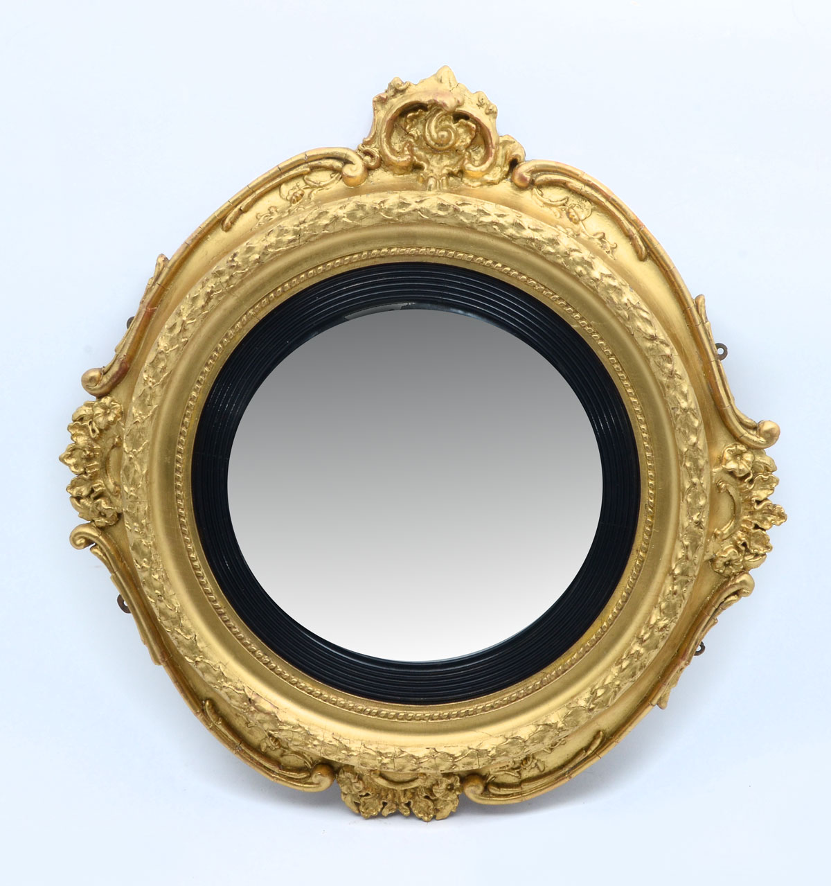 Appraisal: GILT EBONIZED ROCOCCO CONVEX MIRROR Convex mirror with an incised