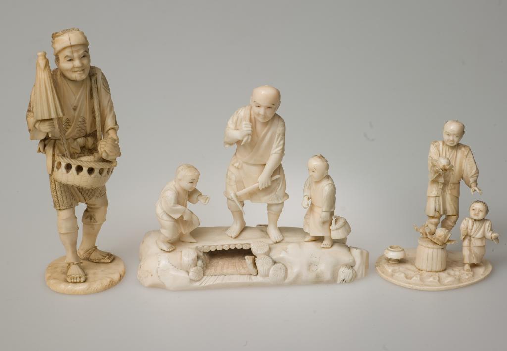 Appraisal: JAPANESE IVORY OKIMONO OF A FRUIT SELLER AND HIS SON