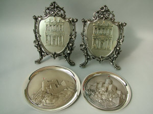 Appraisal: Two contemporary white metal shield shaped plaques depicting Petra Jordan