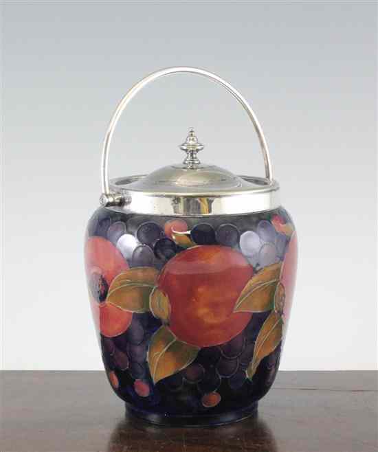 Appraisal: A Moorcroft Pomegranate design biscuit barrel c - with electroplate