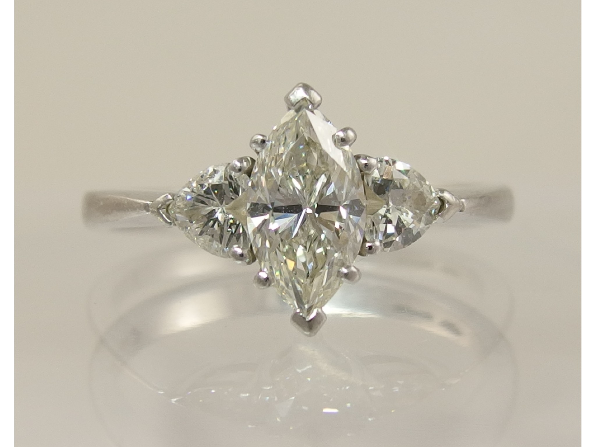 Appraisal: An unusual platinum three stone diamond ringwith a central marquis