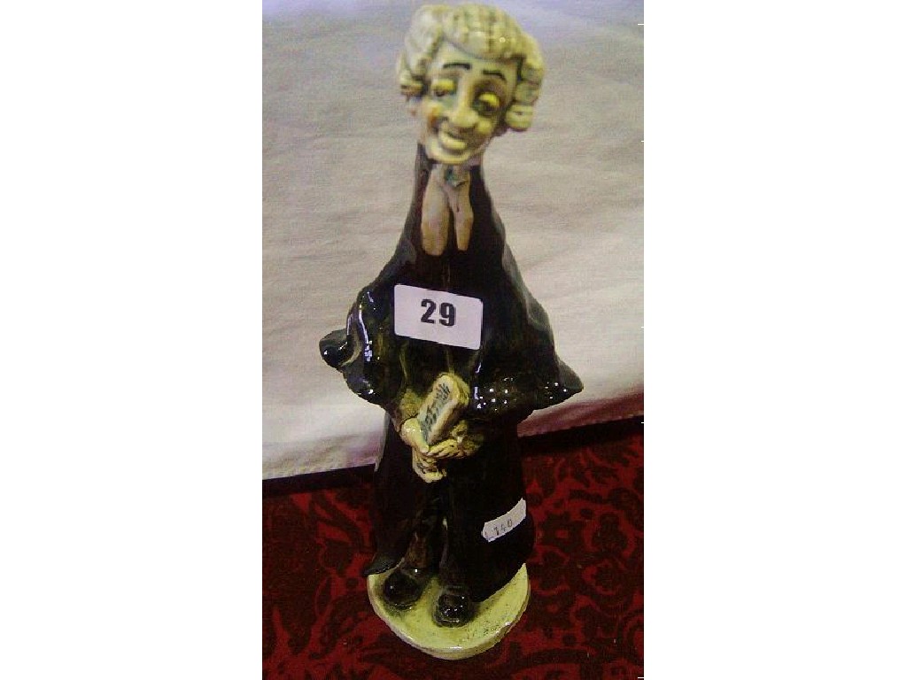 Appraisal: A Norman Underhill pottery figure caricature of a legal character