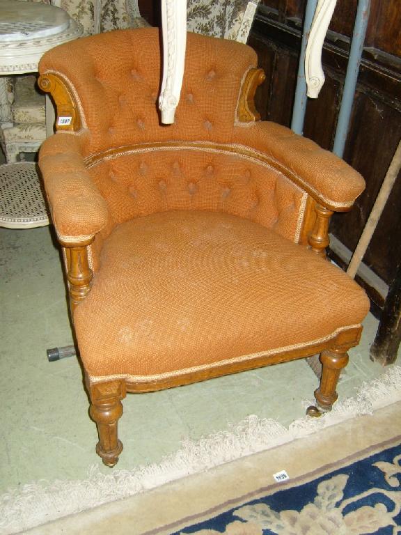 Appraisal: A Victorian oak armchair with button back upholstered seat shaped