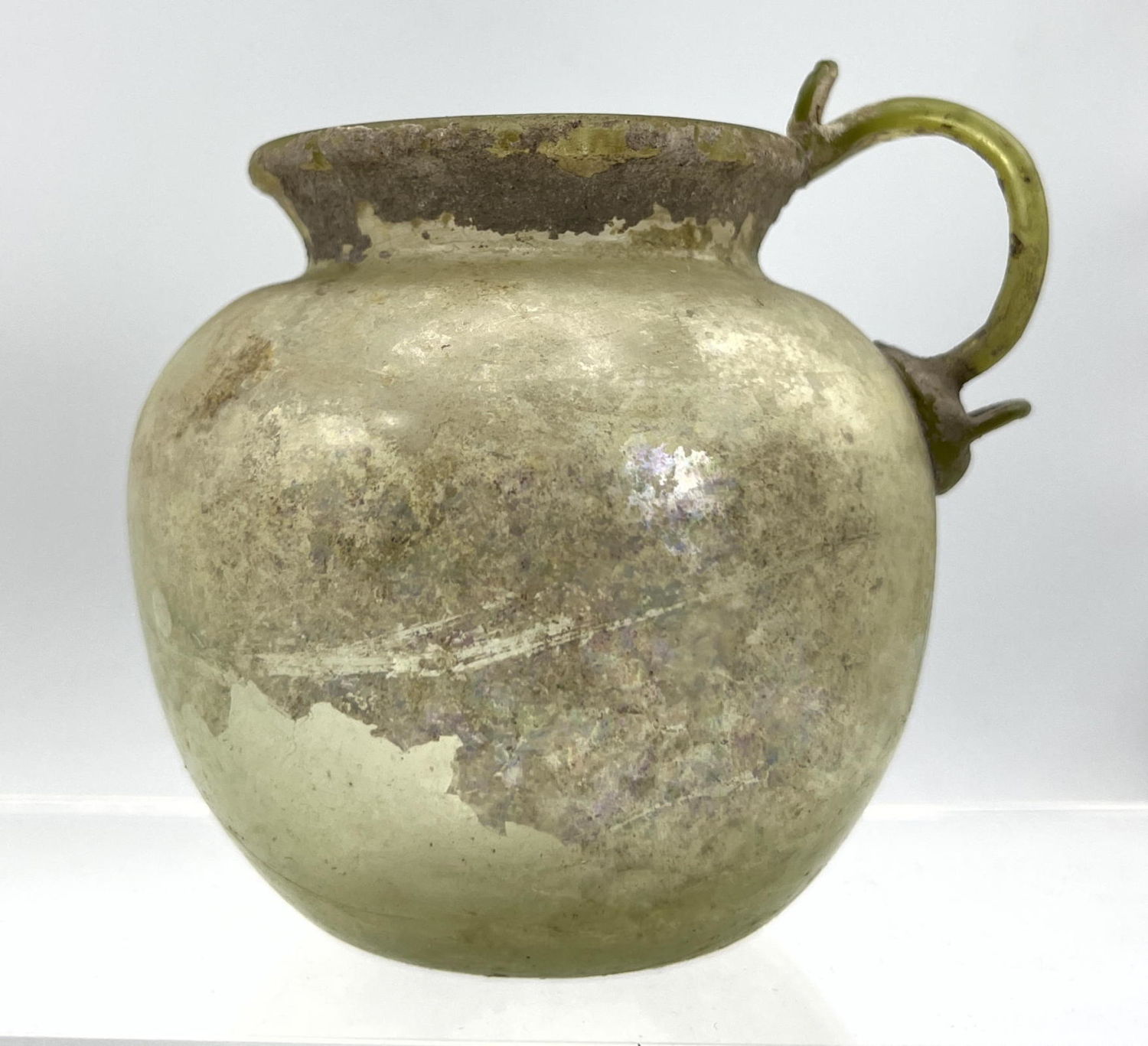 Appraisal: Yellow green bulbous handled jug Ancient Roman glass Dimensions H