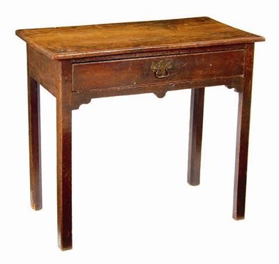 Appraisal: An oak side table the frieze drawer above a shaped