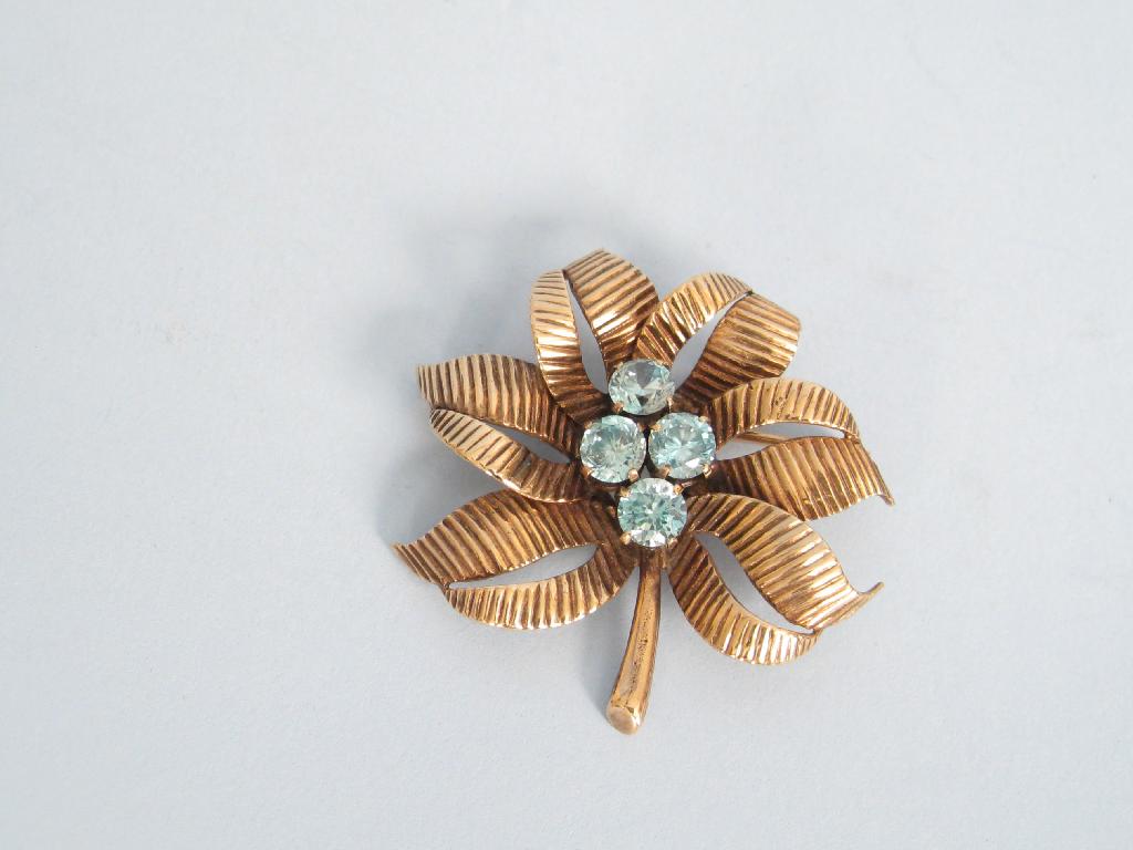 Appraisal: A blue Zircon Brooch claw-set four stones in stylised leaf