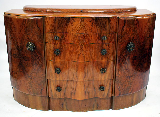 Appraisal: AN ART DECO WALNUT BOW FRONTED SIDE CABINET with lifting