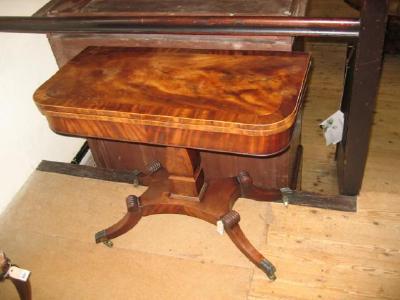 Appraisal: A REGENCY MAHOGANY FOLDING TEA TABLE of rounded oblong form