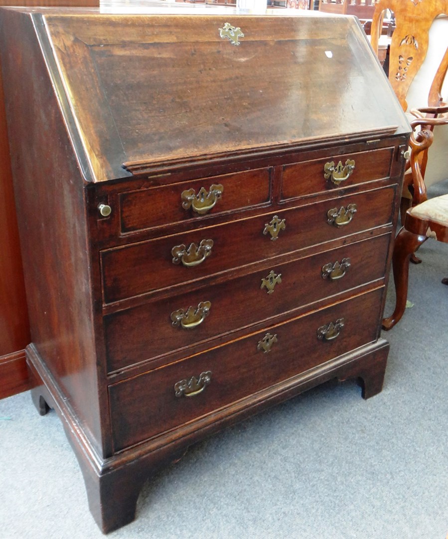 Appraisal: A mid th century mahogany bureau the fall enclosing a