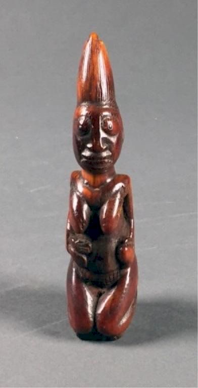 Appraisal: Kneeling ivory female figure A kneeling ivory female figure Nigeria