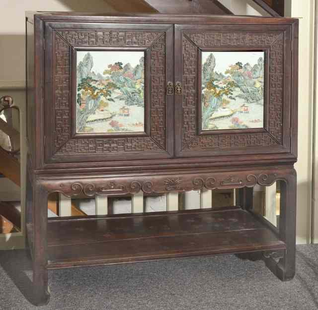 Appraisal: A CHINESE CABINET on stand the panel doors inset with