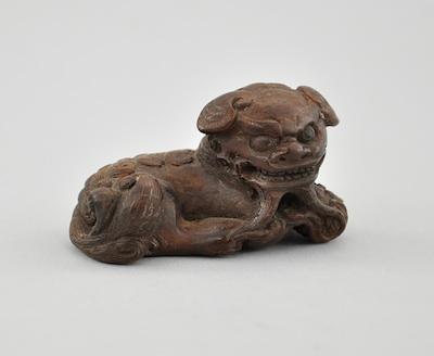 Appraisal: Recumbent Shizui Lion Wood Netsuke Carved in the form of