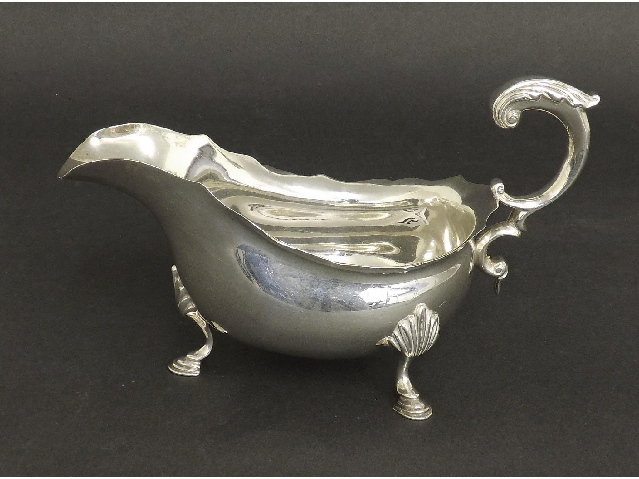 Appraisal: Georgian style silver sauce boat with scrolled acanthus handle and