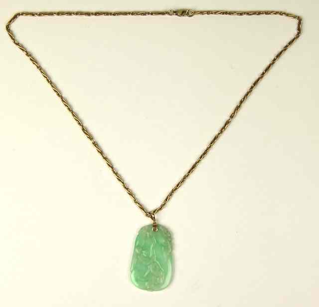 Appraisal: A carved jade pendant of gourd shape the mm x