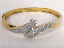 Appraisal: An carat gold diamond set bangle estimated diamond content in