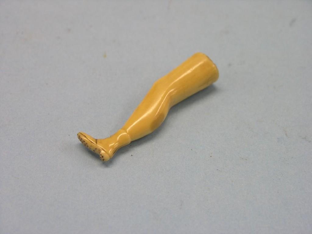 Appraisal: A th century carved bone novelty pipe tamper in the