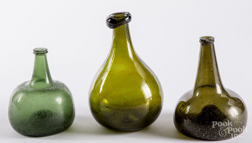 Appraisal: Two blown olive glass squat bottles late th c Two