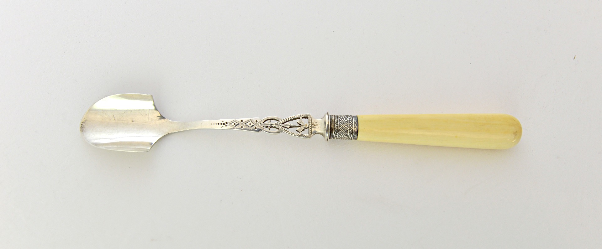 Appraisal: A late Victorian silver cheese scoop with pierced and engraved