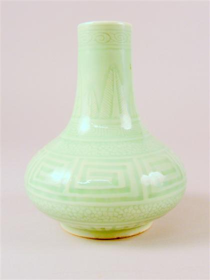 Appraisal: Chinese carved celadon porcelain vase th century Slender neck issuing