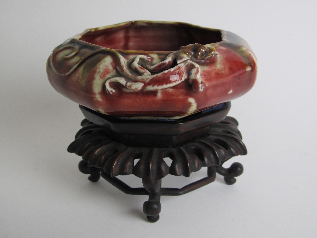 Appraisal: A Chinese octagonal red mottled bowl with a crawling chilong